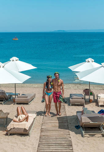 Miraggio customers laying on the sunbeds and walking on the deck