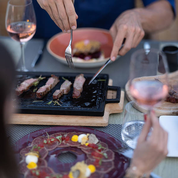 Customers serving themselves from the food on the table