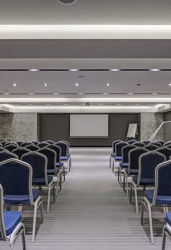 Miraggio Thermal Spa Resort conference presentation room blue chairs and whiteboard