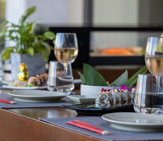 Sushi Bar table for two with plates, dishes and wine