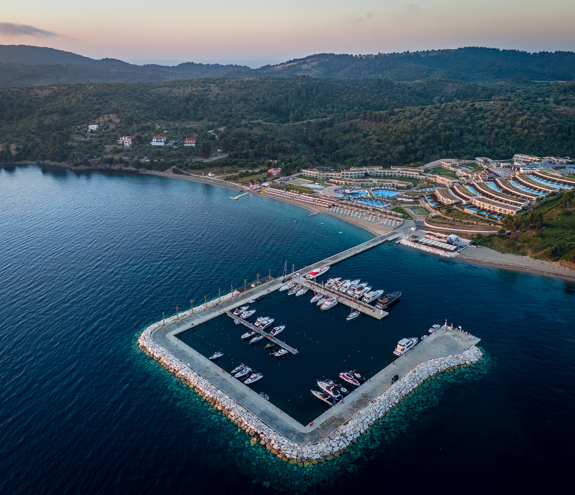 Aerial view of Miraggio Thermal Spa Resort and its private marina surrounded by clear blue waters and lush hills