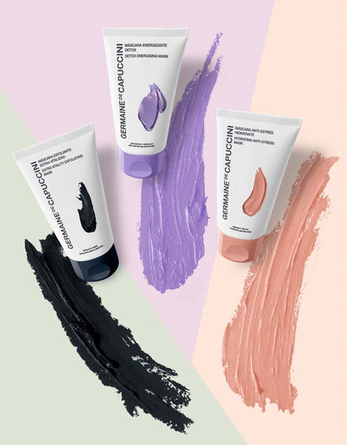 Germaine de Capuccini face masks in black, purple, and peach shades on paster background
