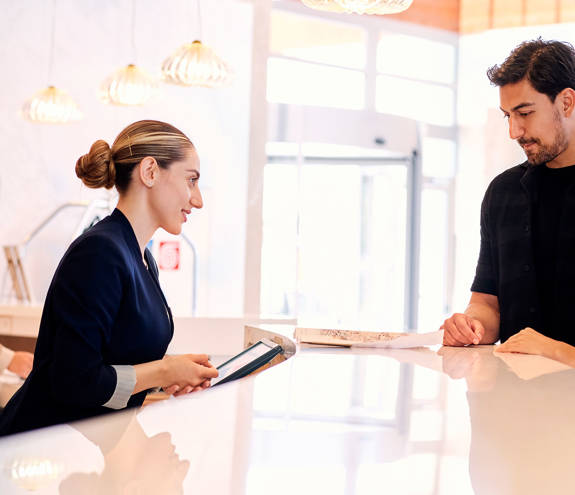 Couple speaking at the receptionist