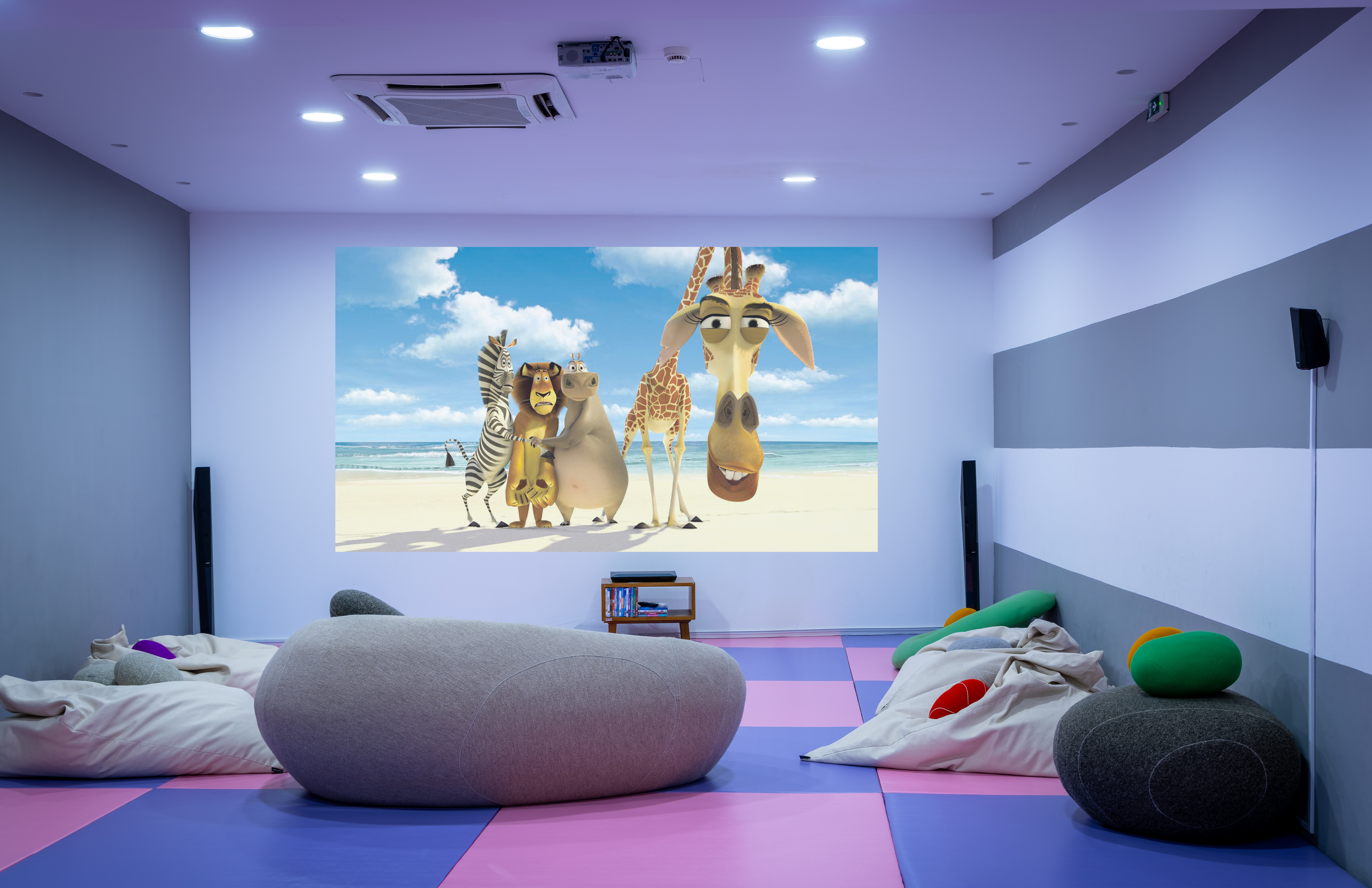 Cozy kids' cinema room with bean and movie projection at Kids Planet