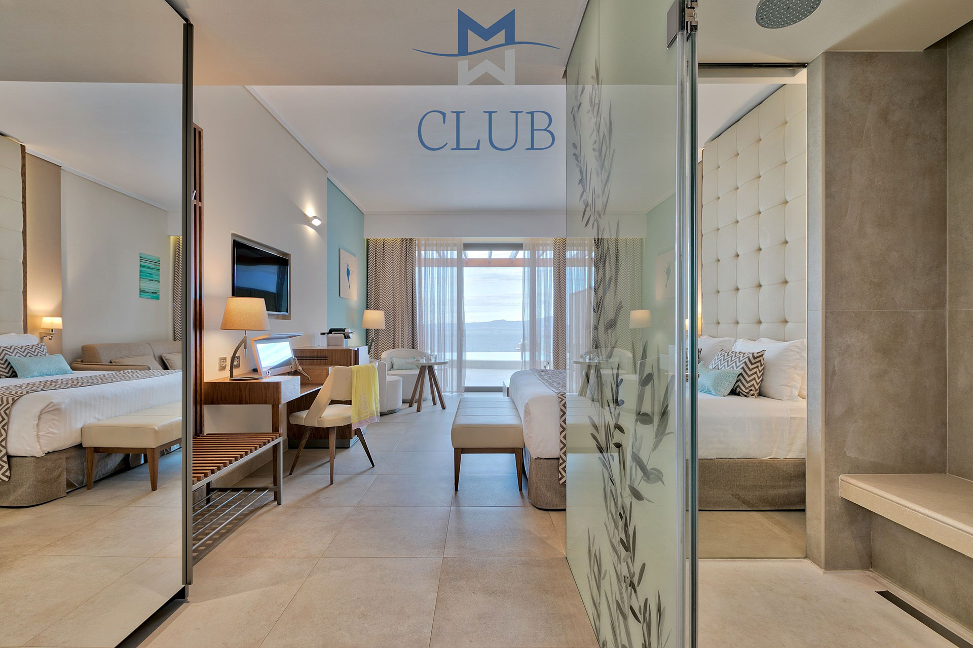 Spacious club sea view room with natural lighting, mirror, working desk and king sized bed