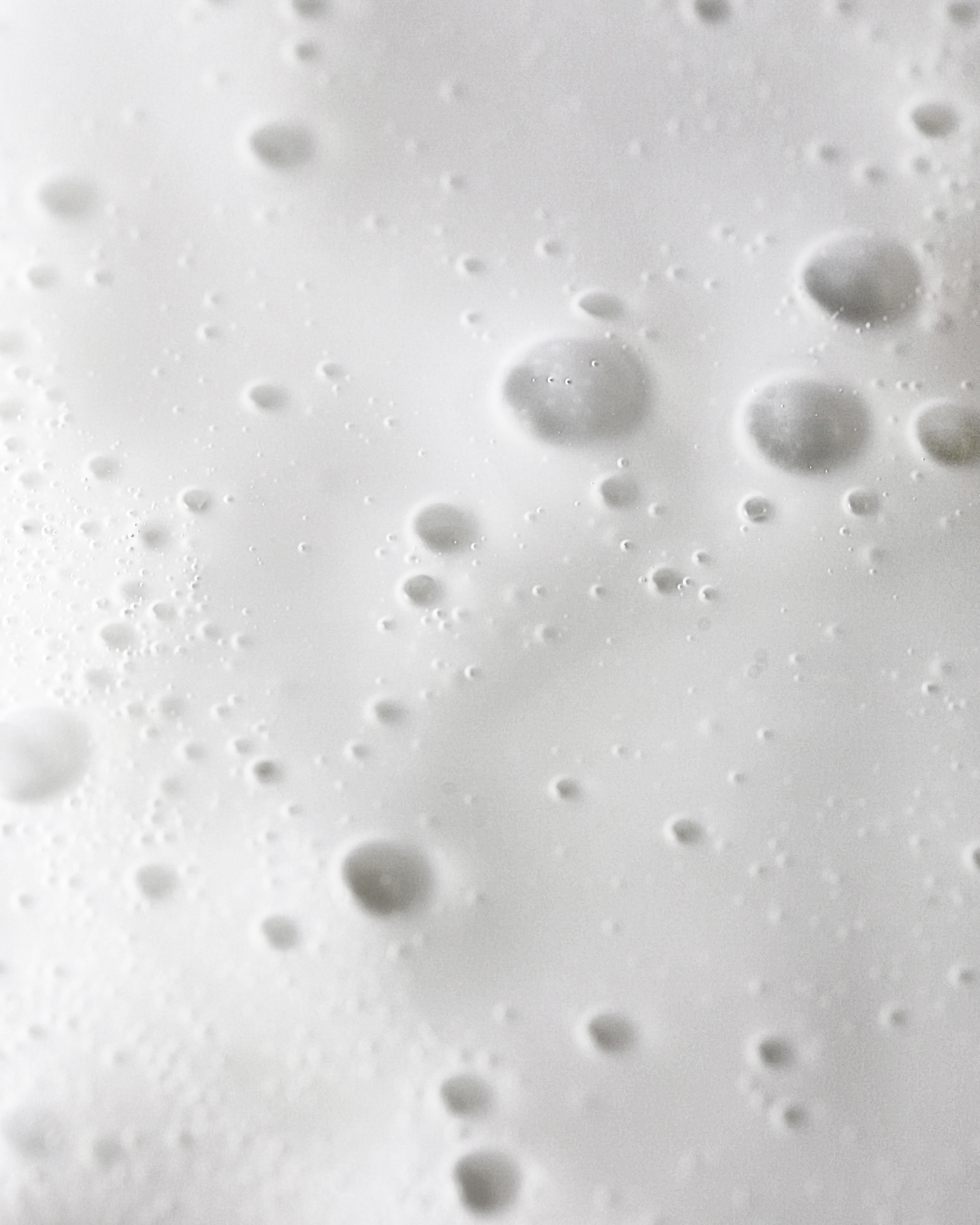 Macro view of creamy skincare texture with soft bubbles symbolizing purity