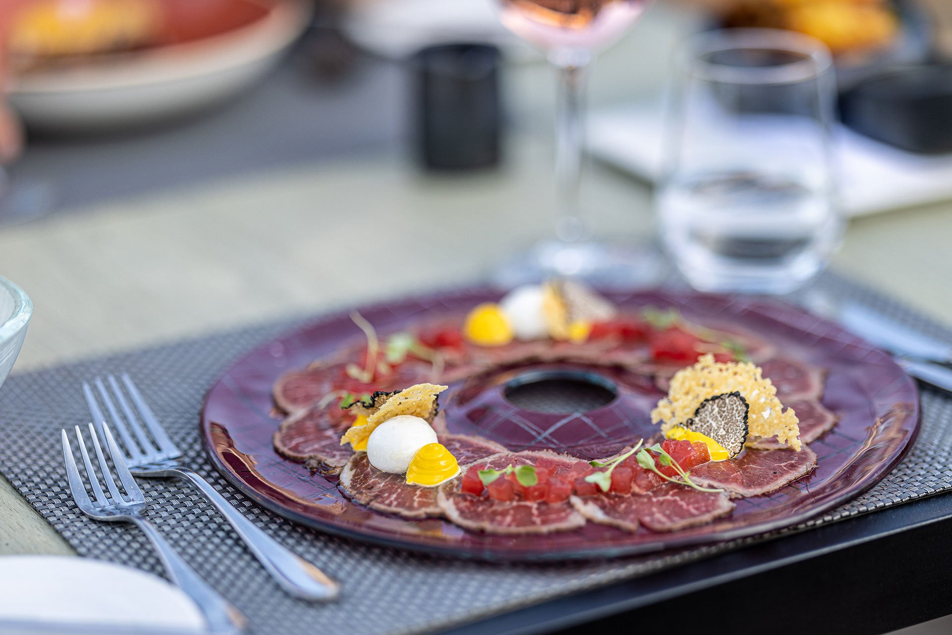 Gourmet beef carpaccio with truffle and artistic plating at Sommelier's 8 restaurant
