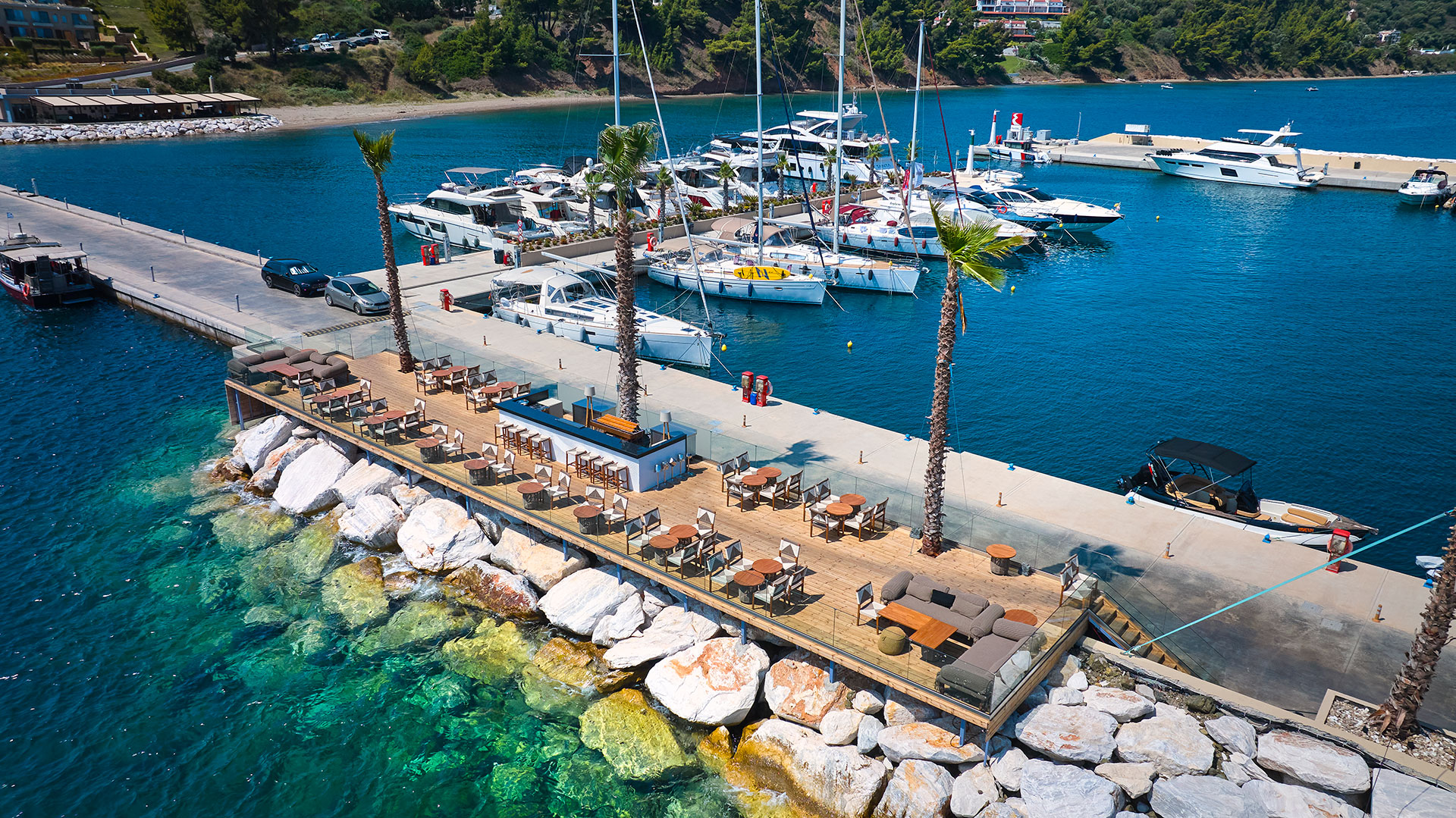 Aerial view of Mirage On The Rocks bar on the marina dock with yachts moored behind