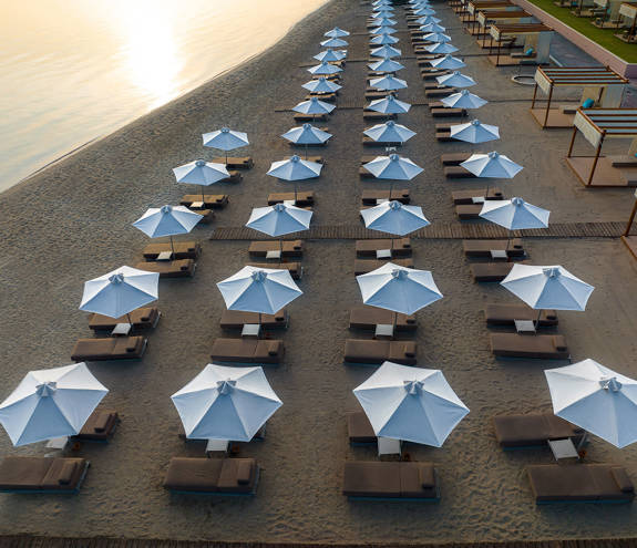 Miraggio beach umbrellas and sunbeds at sunset