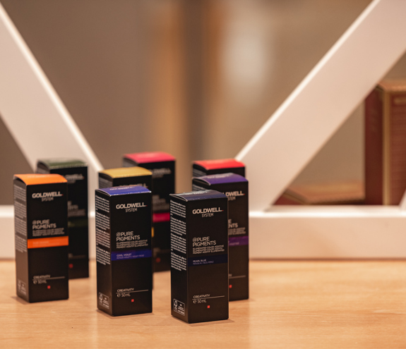 Shelf of premium hair care products displayed on a clean counter at LEFAS Hair Operators in Miraggio 