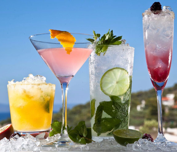 Colorful cocktails and drinks served on a table with ice and fresh lime decorations