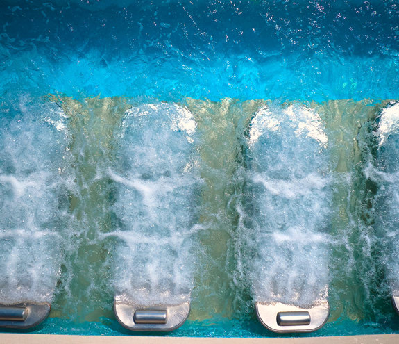 Close-up of underwater hydrotherapy jets bubbling in a thermal pool