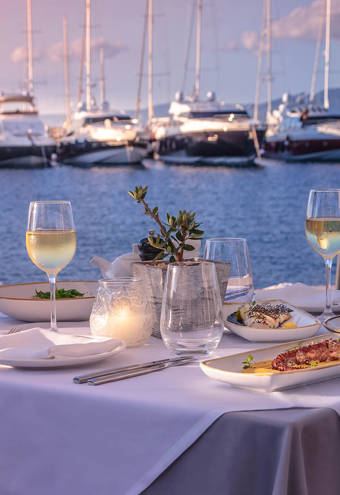 Toroneo Restaurant decorated table for two with dishes and glasses of wine