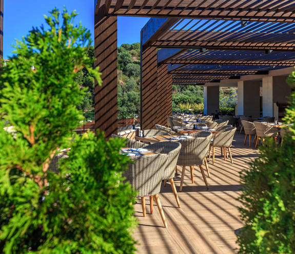 Kritamo Restaurant tables and chairs through two trees