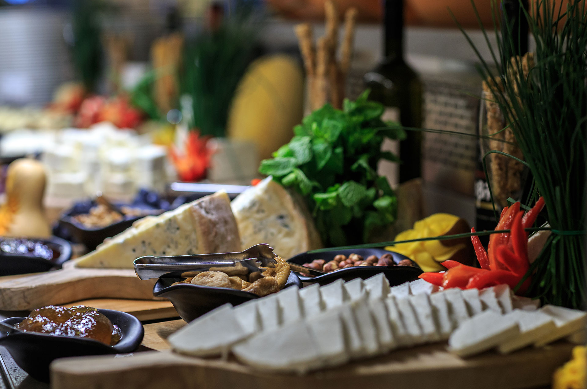 Cheese and charcuterie selection with nuts, jams, and herbs at Kritamo restaurant