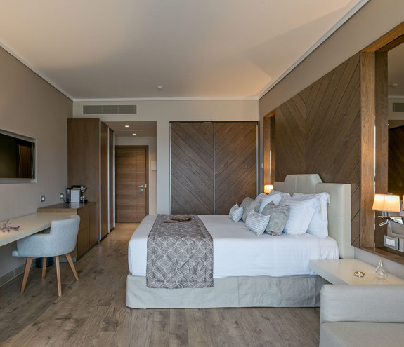 Superior Garden View Room entrance, bed and amenities