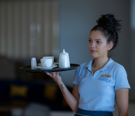 Waitress serving coffee with elegance and professionalism at the lounge