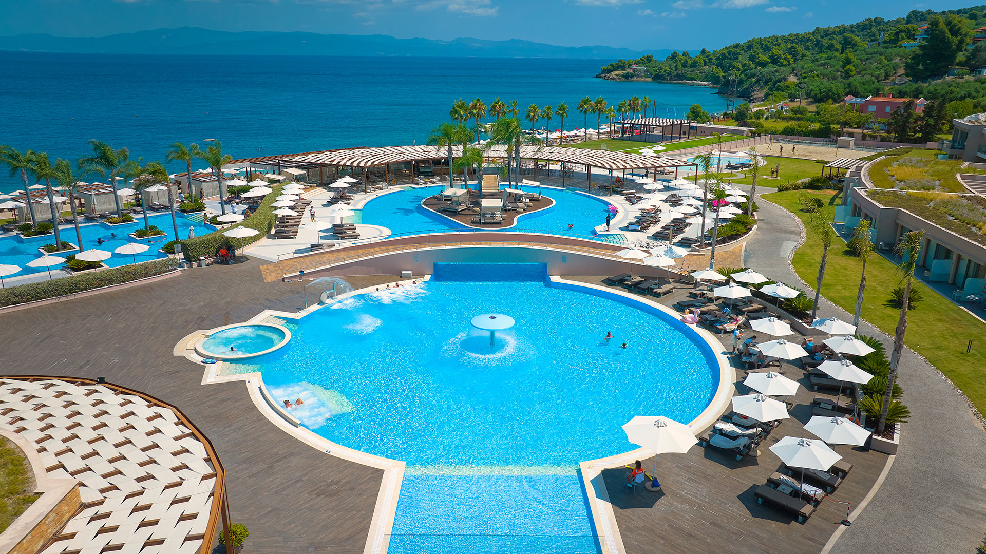 Aerial view of the infinity pools and sun loungers overlooking the Aegean Sea