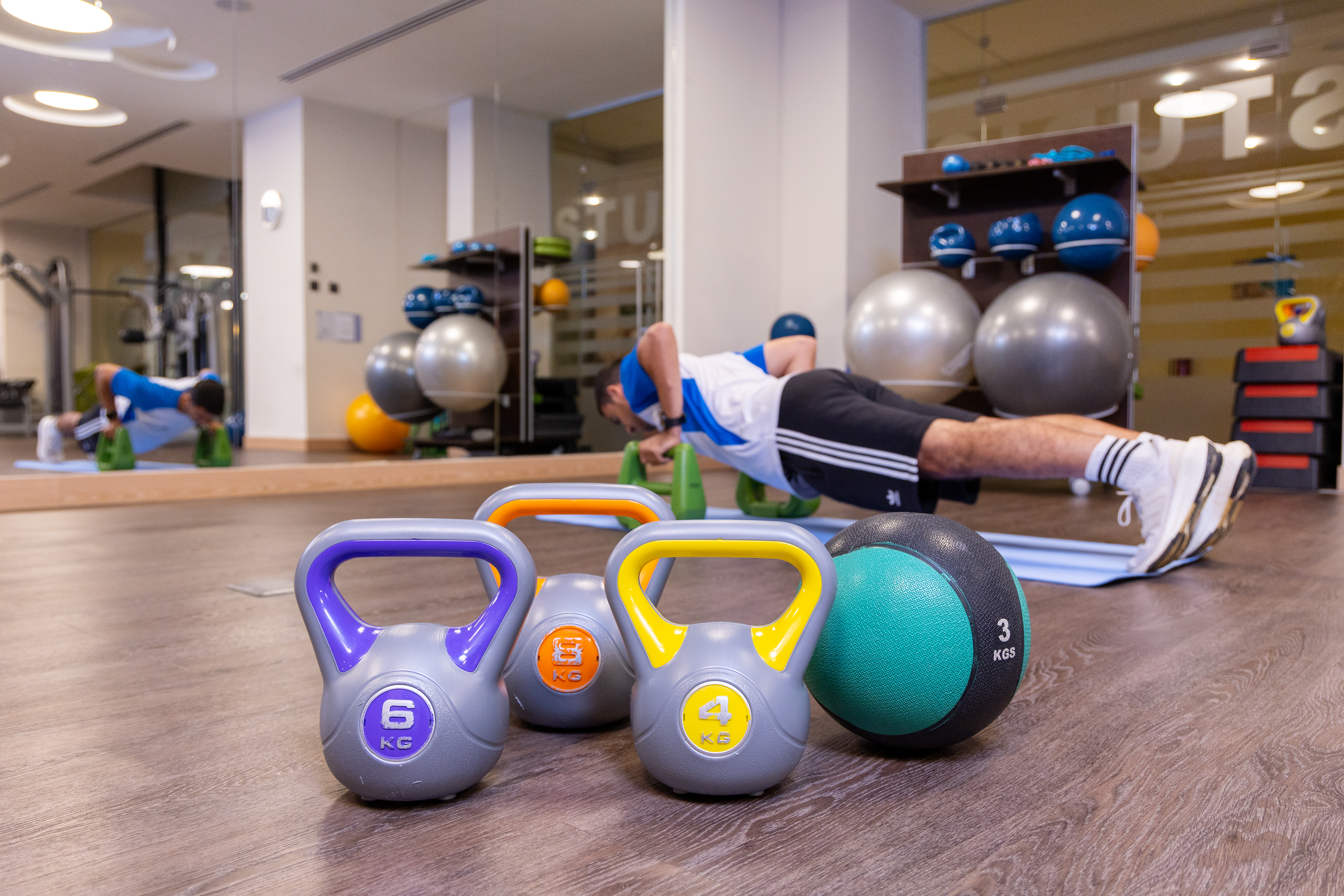 Fitness equipment and free wights inside modern gym area