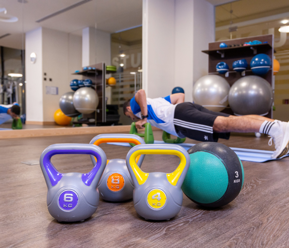 Fitness equipment and free wights inside modern gym area