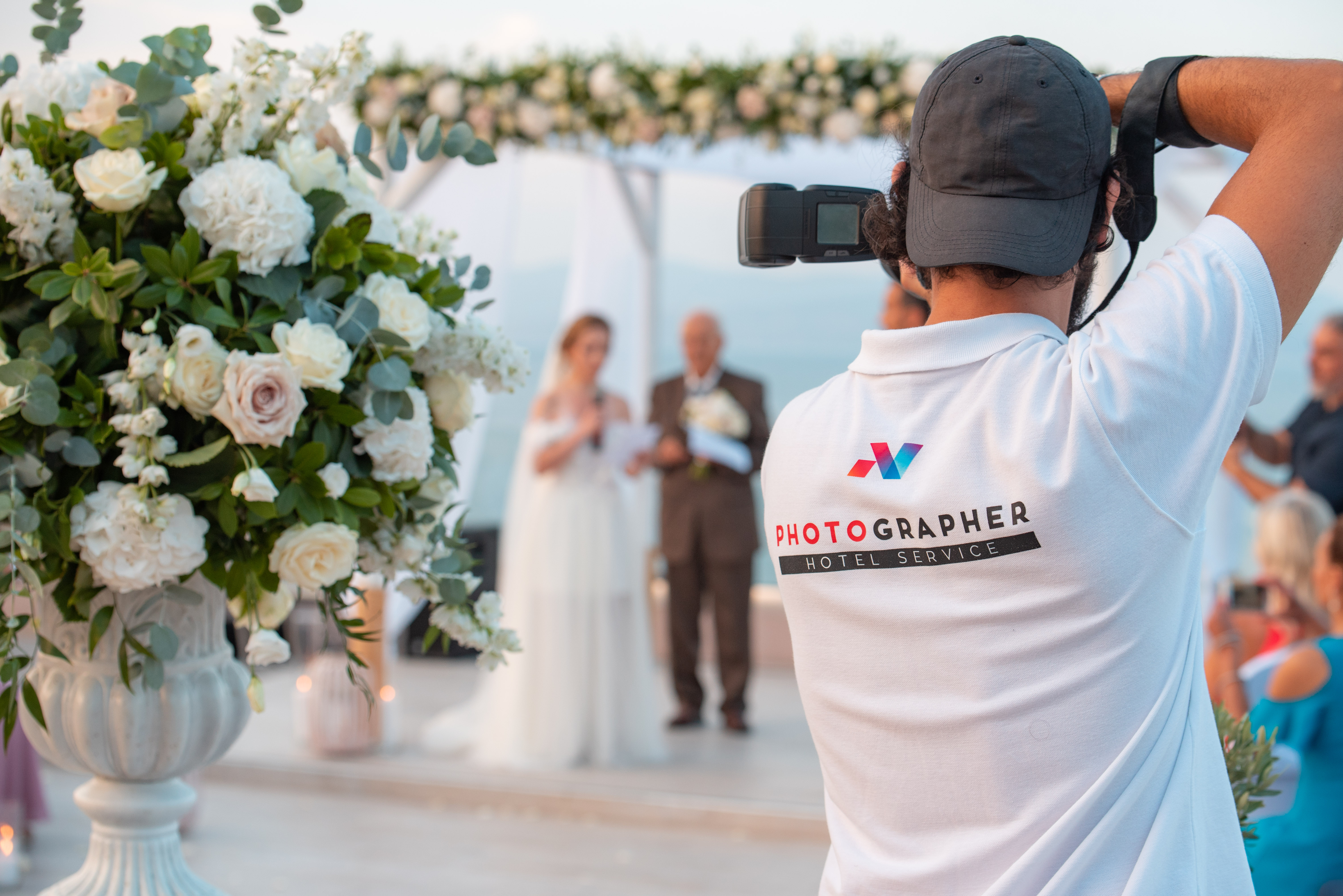 Photographer taking pictures of a bride and a groom at a wedding event in Miraggio