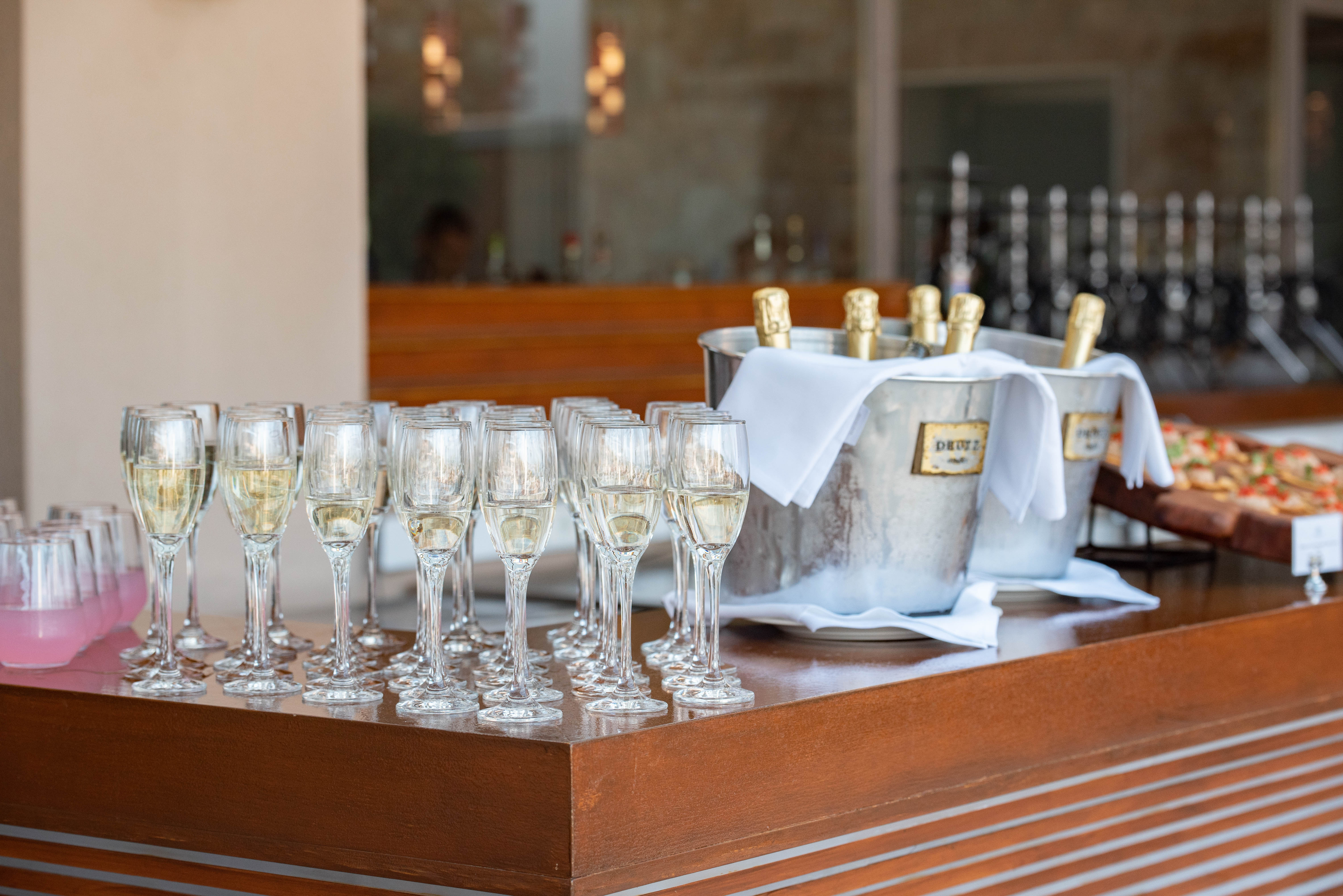 Champagne glasses and chilled bottles prepared for a wedding toast