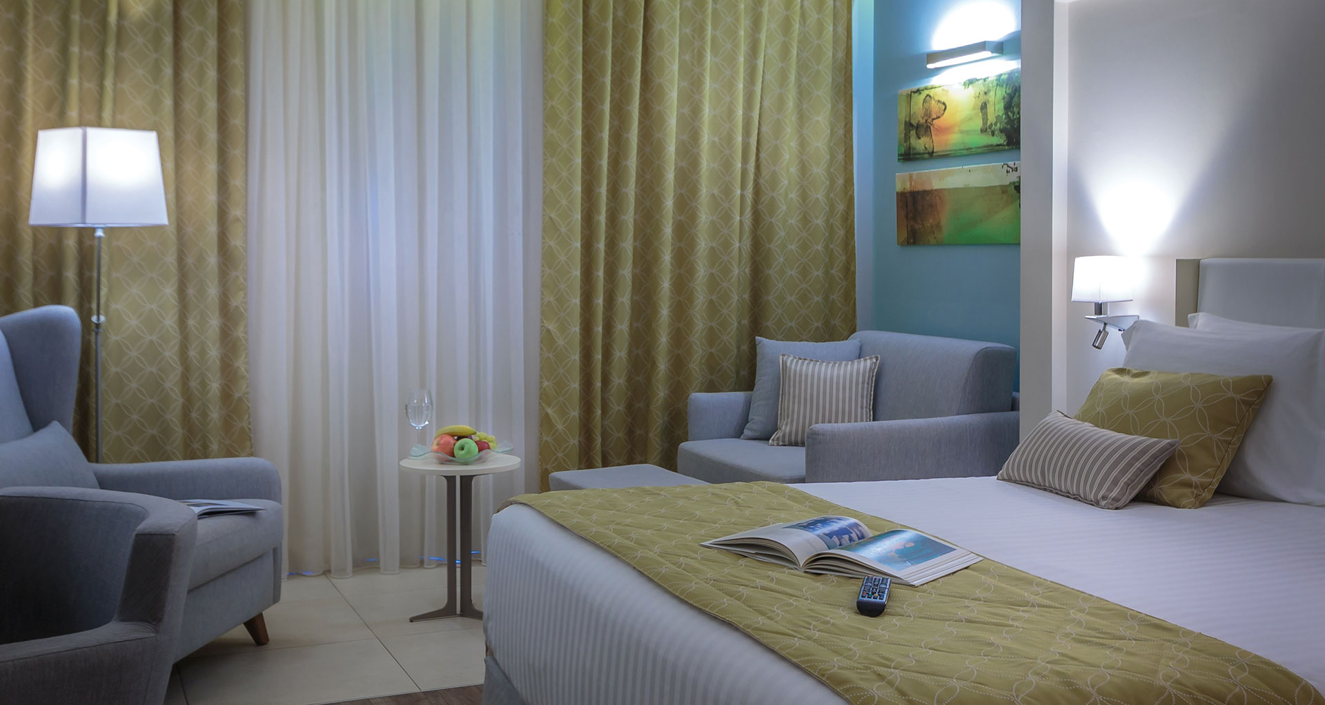 Superior garden view room with king bed, soft lighting and relaxing seating area in elegant design