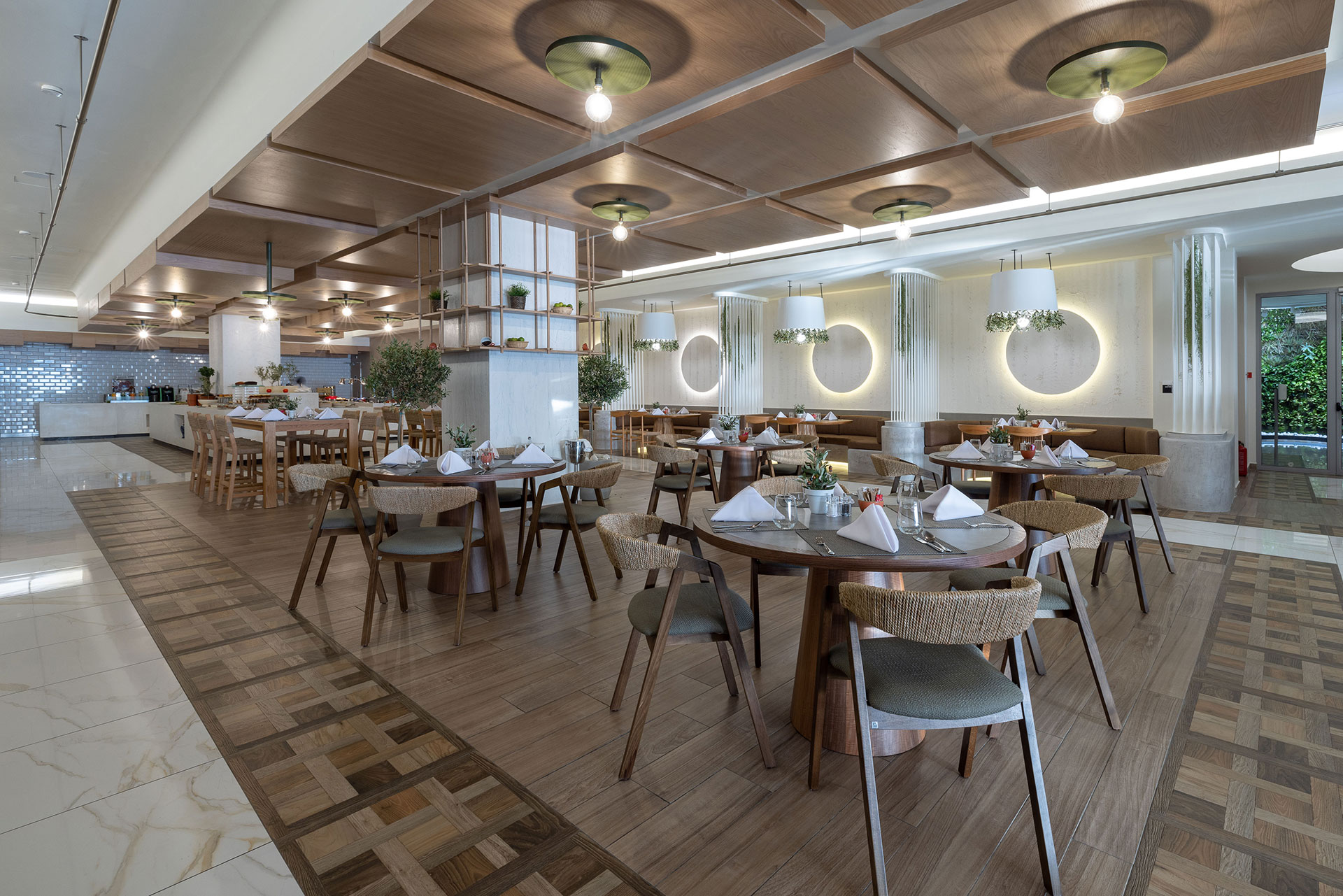 Elegant interior view of Elia restaurant with wooden decor, modern lighting, and neatly set tables