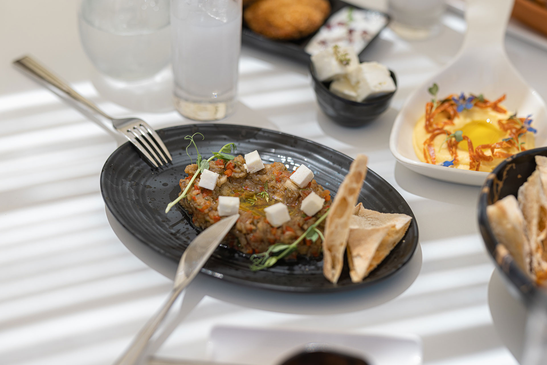 Close up to a meze plate on a served table at Mezedaki beach restaurant