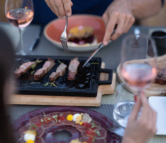 Customers serving themselves from the food on the table