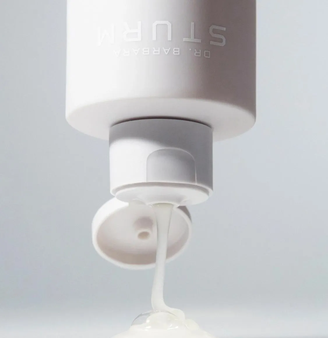 Dr. Barbara Sturm balancing shampoo being dispensed from a white tube