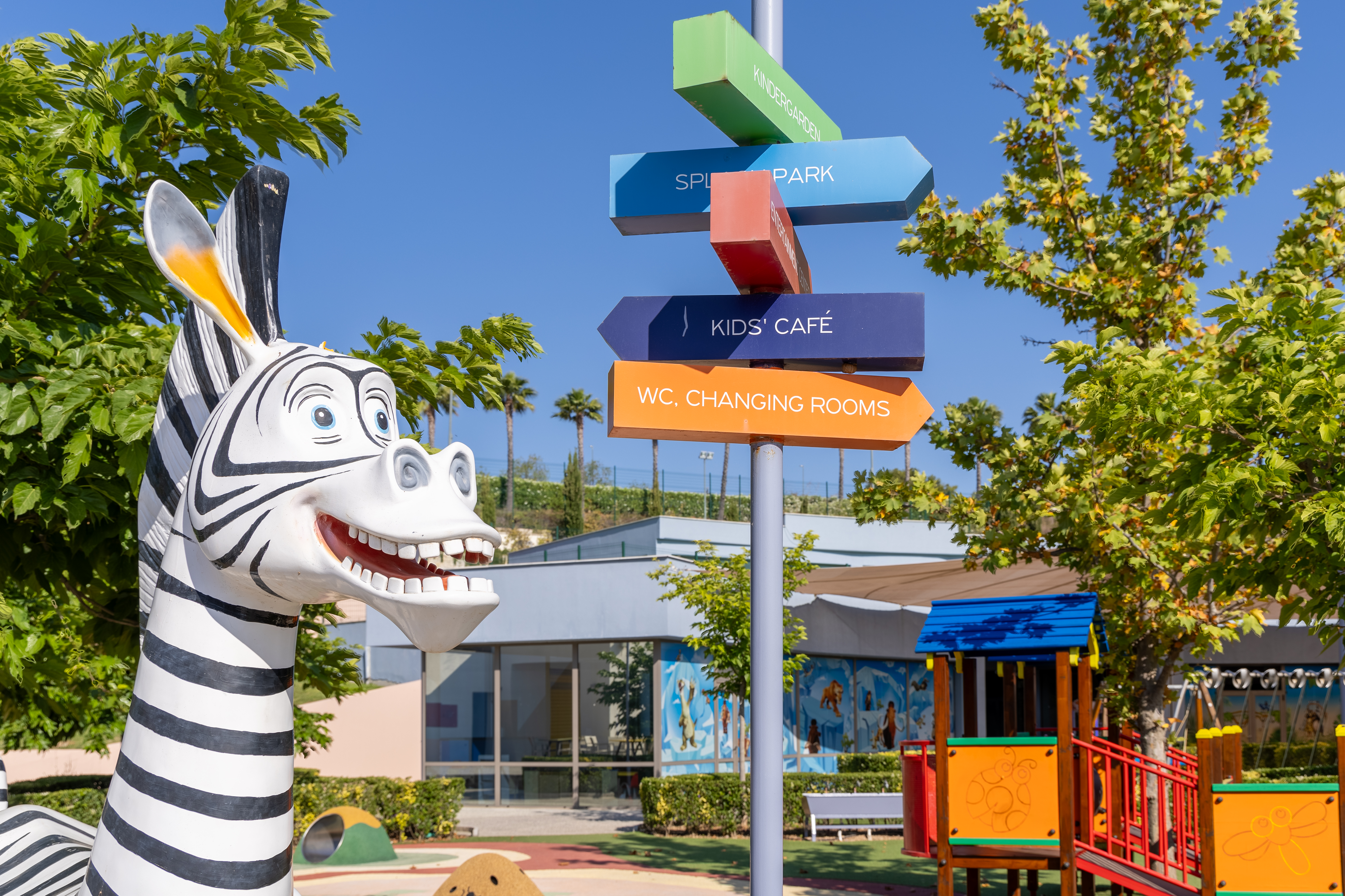 Play zebra statue and colorful direction signs at the outdoor Kids Planet area