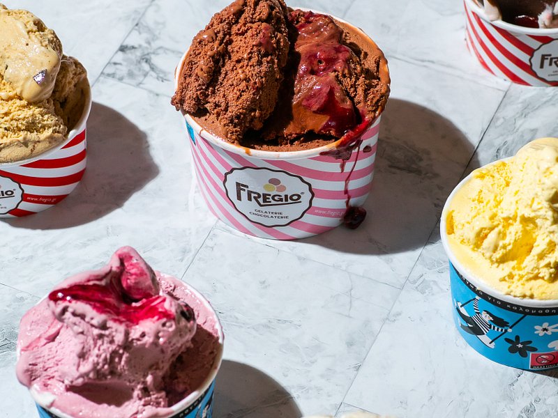 Assorted Fregio ice cream cups with various colorful flavors and toppings