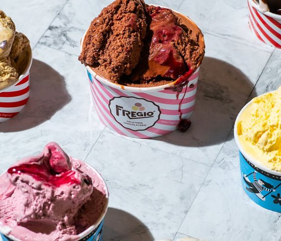Assorted Fregio ice cream cups with various colorful flavors and toppings