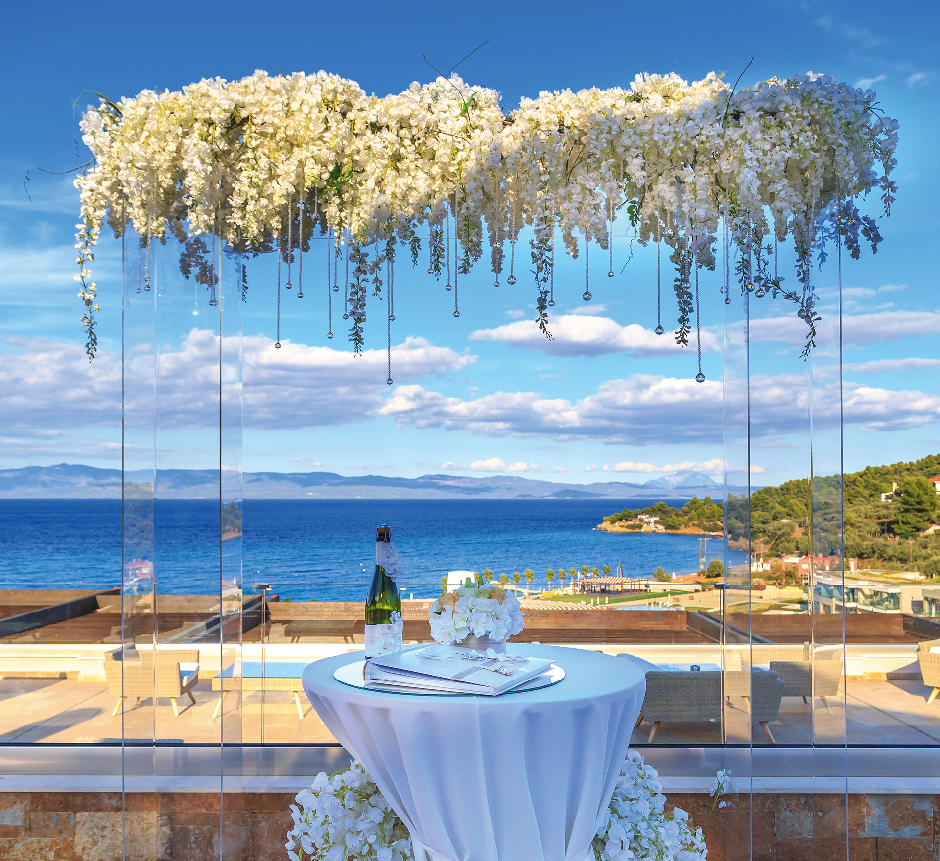 Wedding ceremony table with floral arch and panoramic sea view