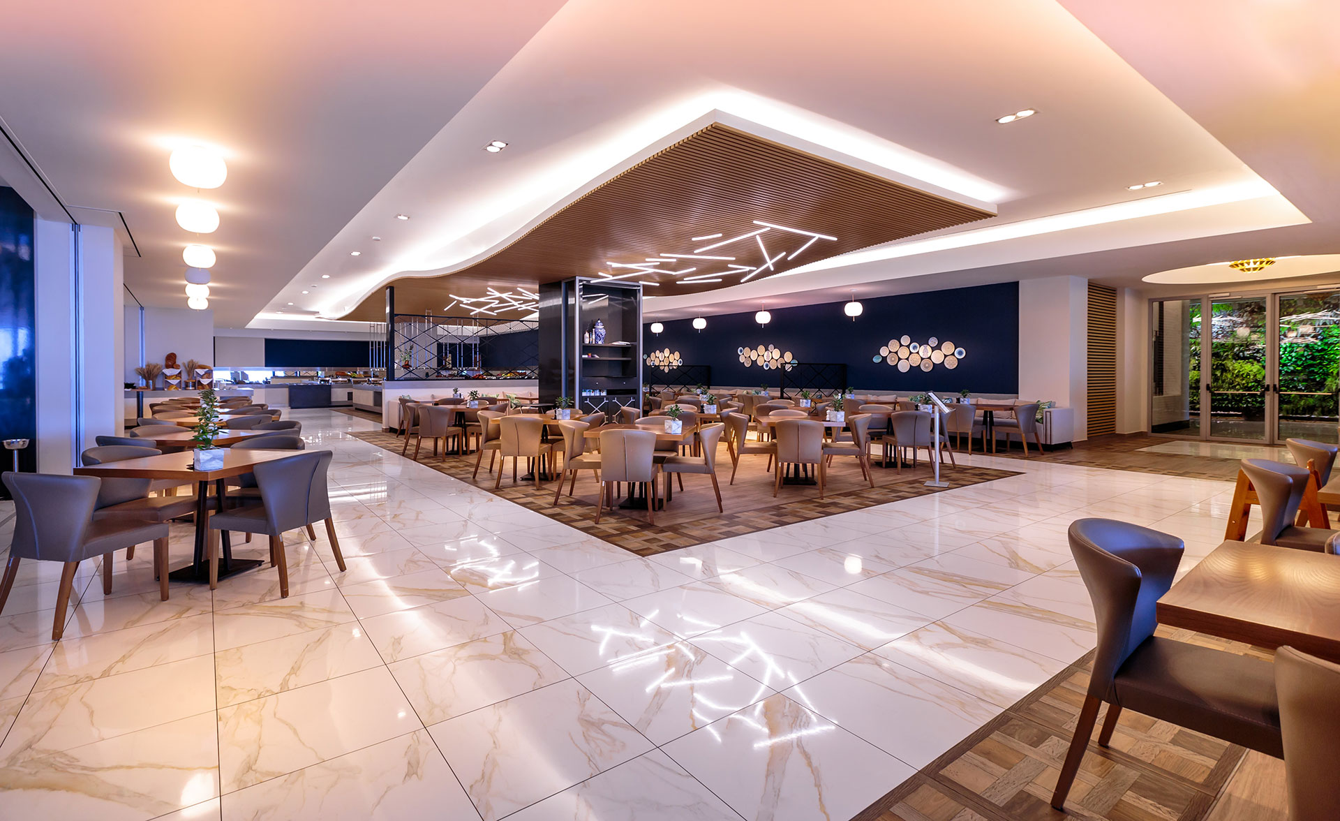Spacious and bright Kritamo restaurant interior with wooden and marble floor, and tables