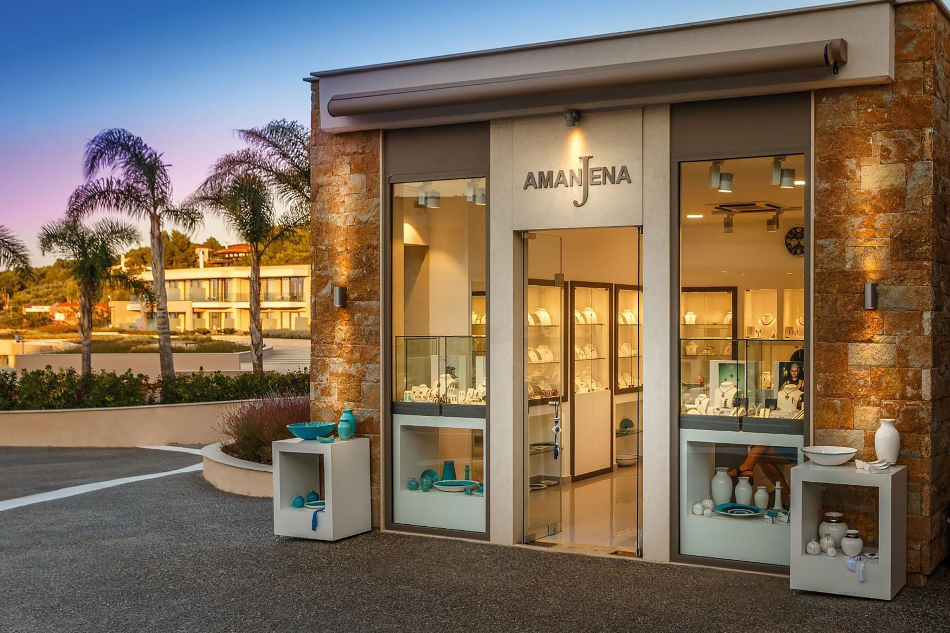 Amajena jewelry store exterior with gold-lit showcases displaying elegant pieces
