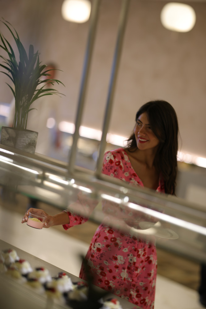 Woman in floral dress choosing a mouse dessert in Kritamo restaurant buffet