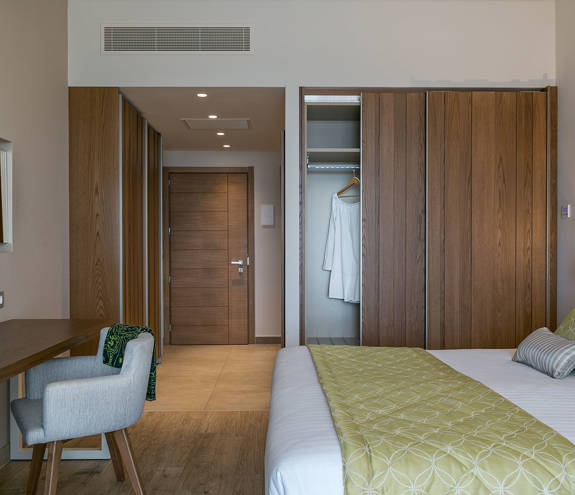 Superior Garden View Room entrance, bed and amenities closeup