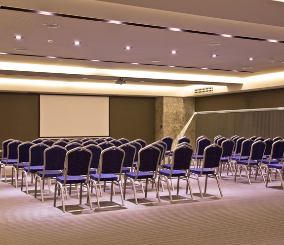 Miraggio Thermal Spa Resort conference brown presentation room with blue chairs and whiteboard