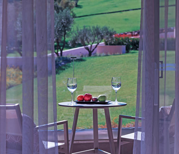 Superior Garden View Room balcony and decorated table with chairs