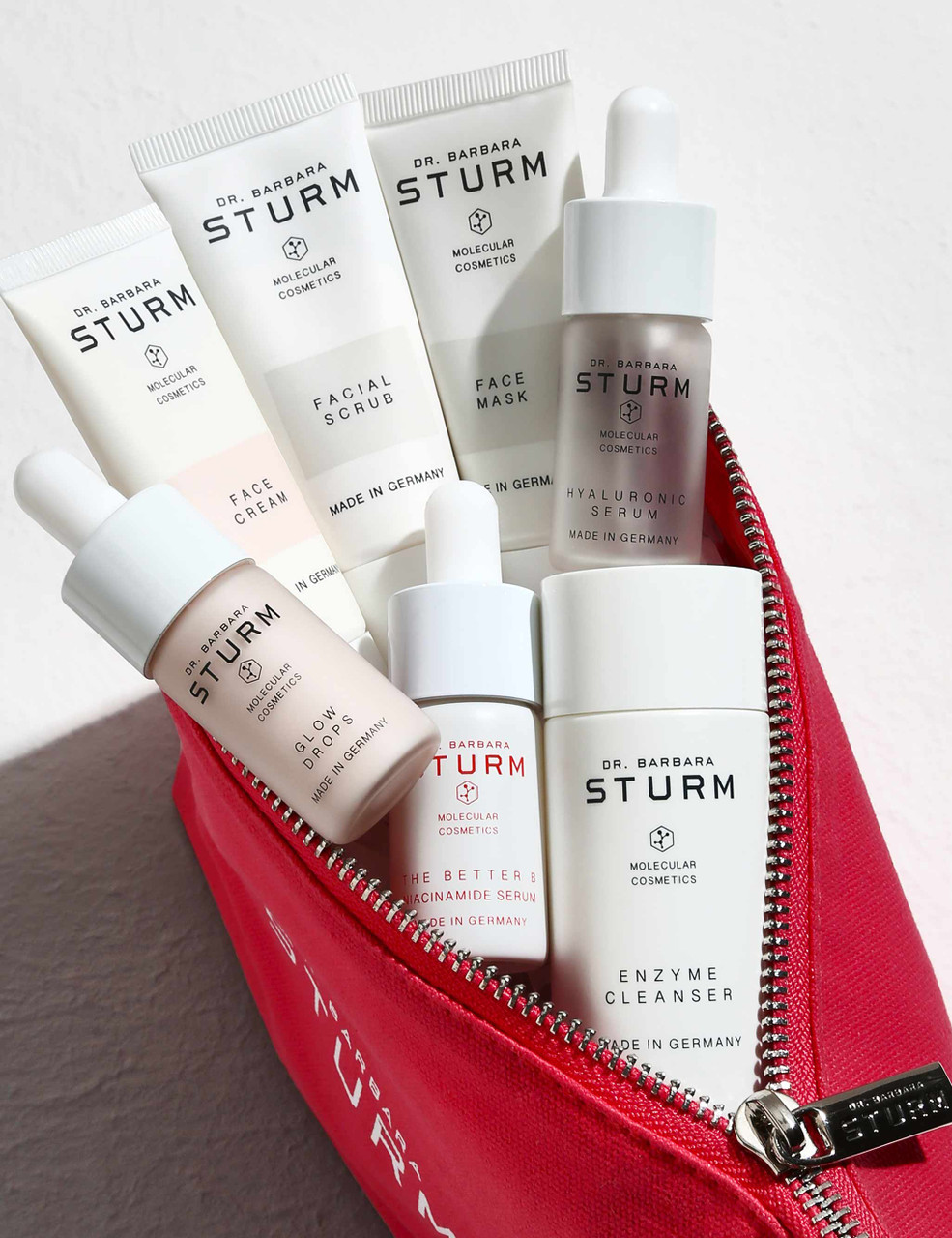 Dr. Barbara Sturm skincare products in a red cosmetic bag at the spa
