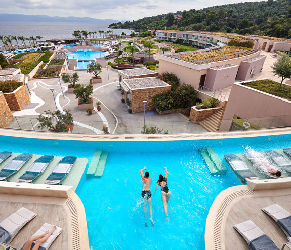 Couple swimming in hydrotherapy pool overlooking the Aegean Sea