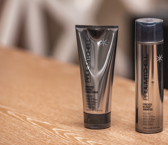 Paul Mitchell Forever Blonde shampoo and conditioner displayed at the beauty salon