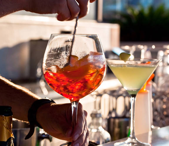 Oasis Beach Bar barman stirs a drink