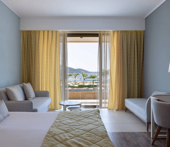 Deluxe Sea View bed, sofas, chair and amenities