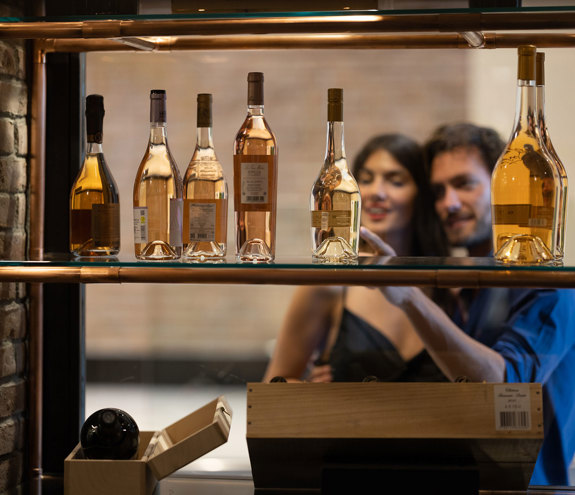 Couple browsing premium wine collection at Sommelier's 8 restaurant wine cellar