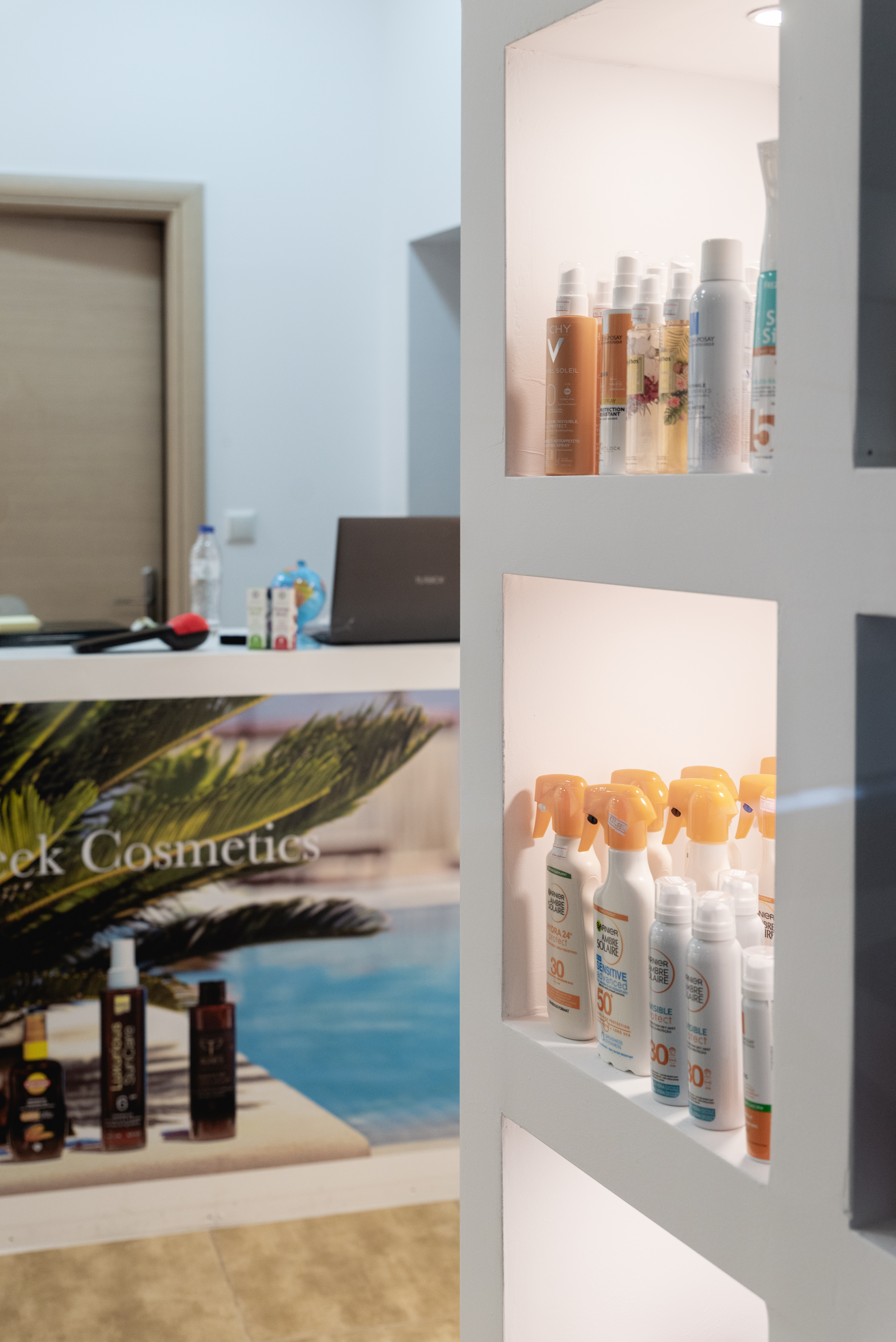 Close up of pharmacy window display featuring sunscreens and skincare products