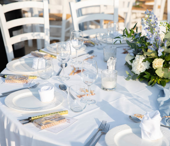 Close up to white flowers placed on a wedding table on the beach