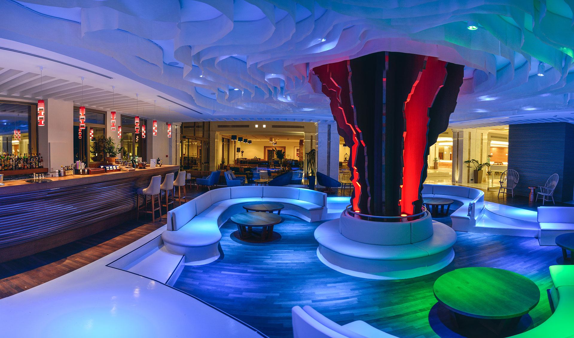 Vibrant Lobby bar interior with colorful ambient lighting in blue, red, and green accents